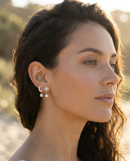Model wearing Moon and Star Earrings made of Gold and Opal