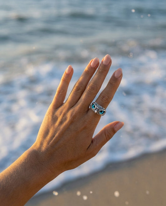 Model wearing Owl of good luck adjustable ring in silver and opal